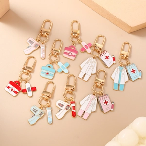 Variety of medical themed enamel keychains including thermometer and first aid kit charms