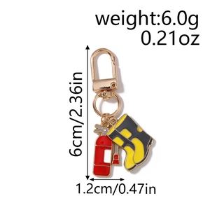 Detail view of firefighter keychain with extinguisher and boot charms showing dimensions