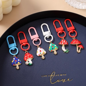 Set of 6 colorful mushroom keychains with speckled patterns and metal lobster clasps