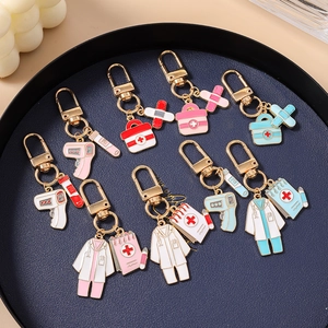 Creative medical themed enamel keychain set with doctor coat and first aid kit charms
