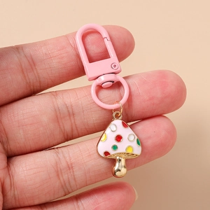 Detail of pink spotted mushroom keychain with colorful enamel dots and lobster clasp