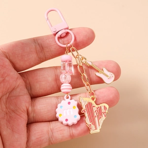 Pink guitar and harp musical instrument keychain with beaded biscuit charm detail