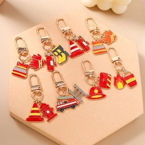 Set of fire department themed enamel keychains with hydrant, helmet and truck