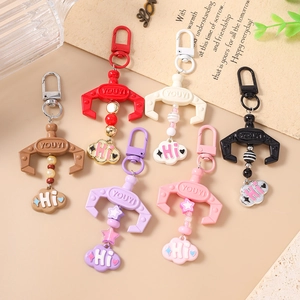 Colorful claw machine charms with beads and cloud pendants on metal keychains