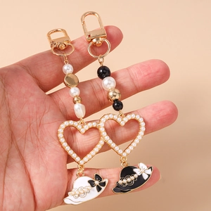 Beaded heart keychains with pearls and lady hat pendants in black and white styles