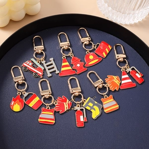 12-piece firefighter enamel keychain set featuring fire truck and extinguisher charms