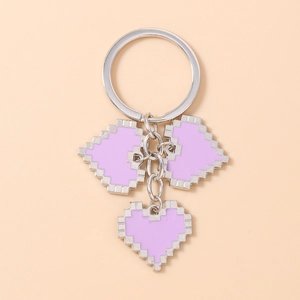 Close-up of triple light purple mosaic pixel heart charms on a silver metal keychain