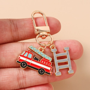 Detail of firefighter truck keychain with red enamel charm and ladder accessory
