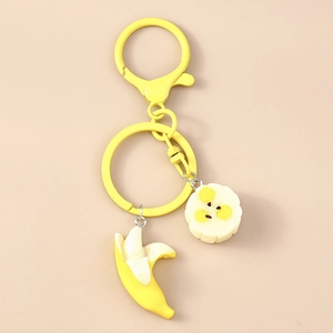 Detail of yellow banana keychain with realistic fruit charms and matte yellow hardware