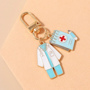 Detail of medical nurse keychain with white lab coat and blue medical notebook charms