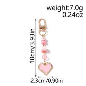 Detail view of pink pixel heart keychain with dimensions and weight measurements