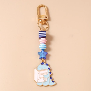 Détail du porte-clés dinosaure avec fermoir doré et perles acryliques bleues