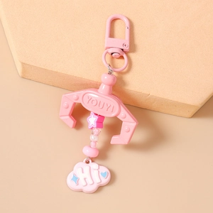Detail of pink claw machine keychain with star beads and cute cloud pendant for bags