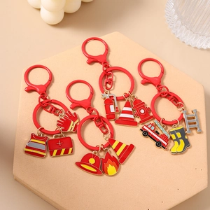 Firefighter themed keychain set with red metal charms including fire truck and helmet