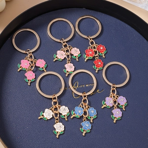 Set of six colorful enamel rose keychains with gold metal rings and small crystal accents
