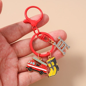 Detail of firefighter keychain with red truck, yellow boot and ladder metal charms