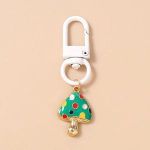 Detail of colorful spotted mushroom keychain with white snap hook and gold-plated finish