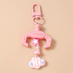 Detail of pink claw machine keychain with star beads and cloud pendant showing YOUYI logo