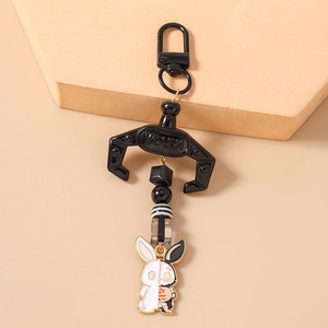 Detail of creative black and white rabbit keychain with mechanical bone patterns