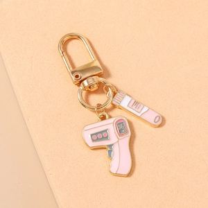 Detailed close-up of pink thermometer and test tube charms on a medical theme keychain