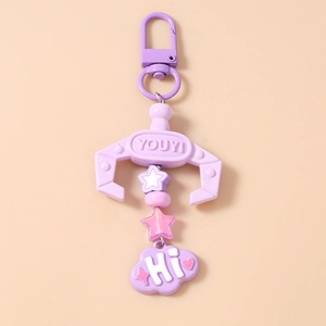 Detailed view of purple claw machine keychain with star beads and Hi cloud pendant