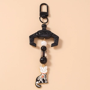 Detail of gothic beaded cat keychain with black skull motif and crescent moon pendant