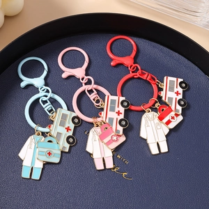 Detail view of medical theme keychains with nurse uniform ambulance and first aid kit charms