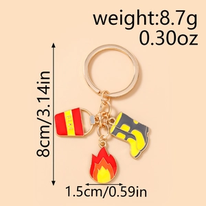 Detail view of firefighter keychain with red fire bucket, boot and flame charms