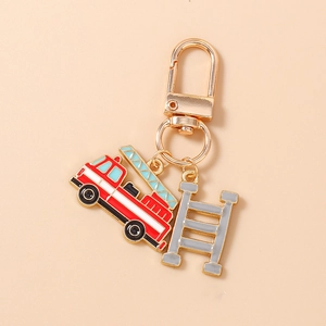 Detailed view of firefighter keychain with red fire truck and ladder charms in gold finish
