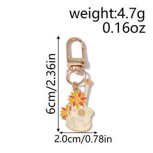 Détail du porte-clés guitare tournesol avec dimensions 6cm x 2cm et poids 4,7g