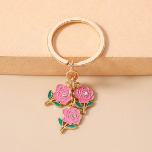 Close-up of pink enamel rose keychain with sparkling crystal and gold metal finish