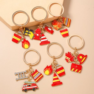 Gold firefighter keychain set featuring fire truck, hydrant and helmet charms