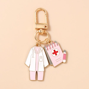 Detail of medical nurse uniform keychain with pink notepad charm and golden metal clip