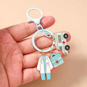 Detail of medical keychain with nurse uniform, ambulance, and first aid kit charms