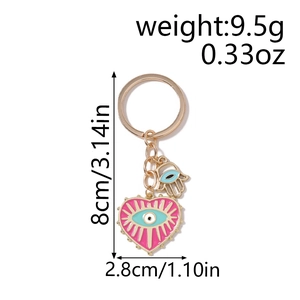 Porte-clés cœur rose avec œil et main de Hamsa, dimensions 8cm x 2,8cm, pesant environ 9,5g