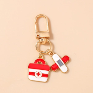 Detailed close-up of medical keychain with first aid kit and bandage charms in cartoon style