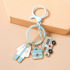 Detail of medical keychain with enamel charms of nurse uniform, ambulance, and first aid kit