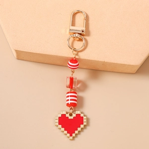 Detail of red pixel heart keychain with gold-plated lobster clasp and decorative beads
