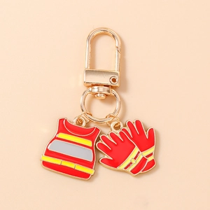 Detail of firefighter gear keychain featuring red safety vest and glove charms