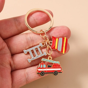 Detail of firefighter keychain with red fire truck and vest charms on gold ring