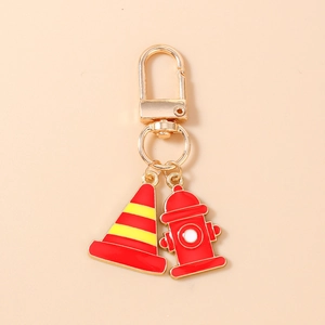 Detail of creative fire hydrant and traffic cone charms on a gold alloy keychain