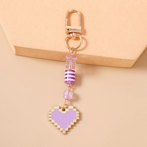 Detail of purple pixel heart pendant with gold clasp and decorative beaded charms