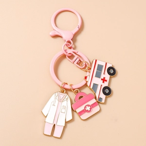 Detailed close-up of pink medical charms including nurse uniform and ambulance keychain