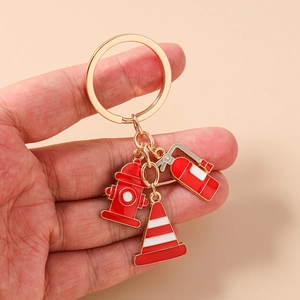 Detailed view of firefighter keychain with red hydrant, cone, and extinguisher charms