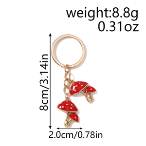 Detail showing dimensions of red mushroom keychain, 8cm long and weighing 8.8g