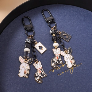 Gothic cartoon animal keychains featuring skeleton rabbit and black cat with poker charms