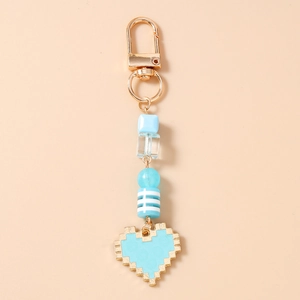 Detail shot of blue pixel heart keychain with golden clasp and acrylic beads