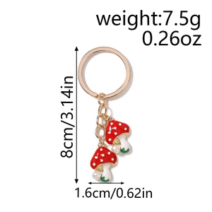 Detail showing dimensions of red mushroom keychain with pearls and golden metal ring