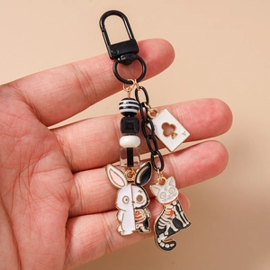 Gothic keychain detail with rabbit and cat skeletons, beads and poker card pendant