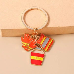 Detailed macro shot of firefighter keychain with red fire vest and bucket charms